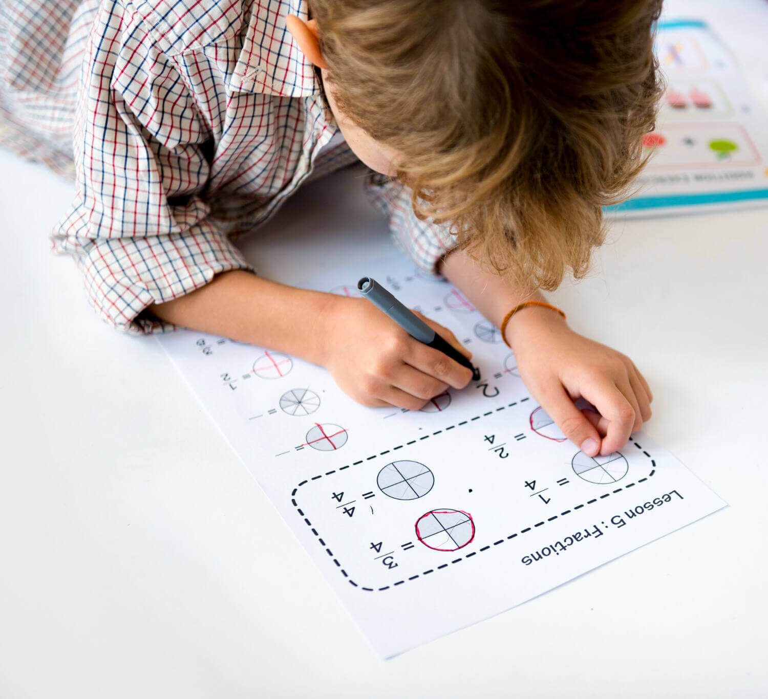 kid answering printable worksheet at home