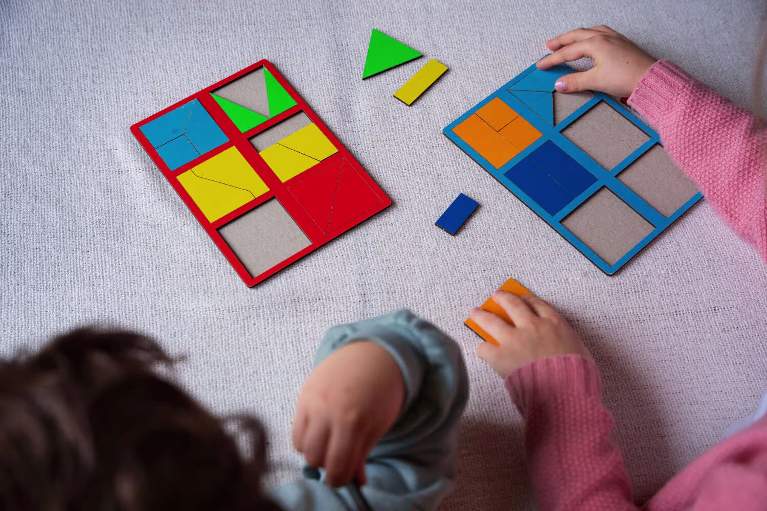 kids playing a colorful shape sorting game as part of early math activities